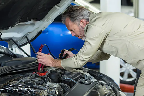 roadside assistance in tampa mechanic-attaching-jumper-cables-car-battery roadside assistance in tampa mechanic attaching jumper cables car battery