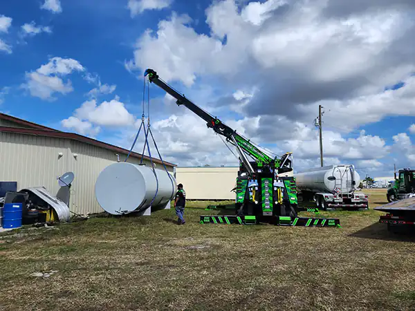 A wrecker lifting a Tank