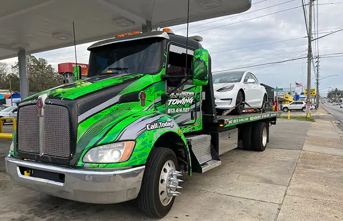 Flatbed with a white car