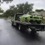 Flatbed on the road transporting a green Lamborghini.